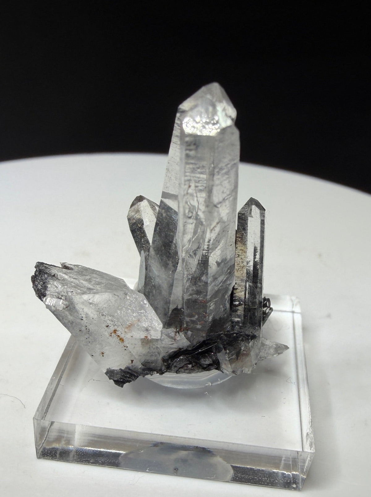 Clear quartz crystals with dark platy hematite from Jinlong Hill, Heyuan, Guangdong, China
