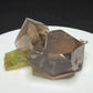 Green elbaite tourmaline crystal on smoky quartz from Paprok, Afghanistan