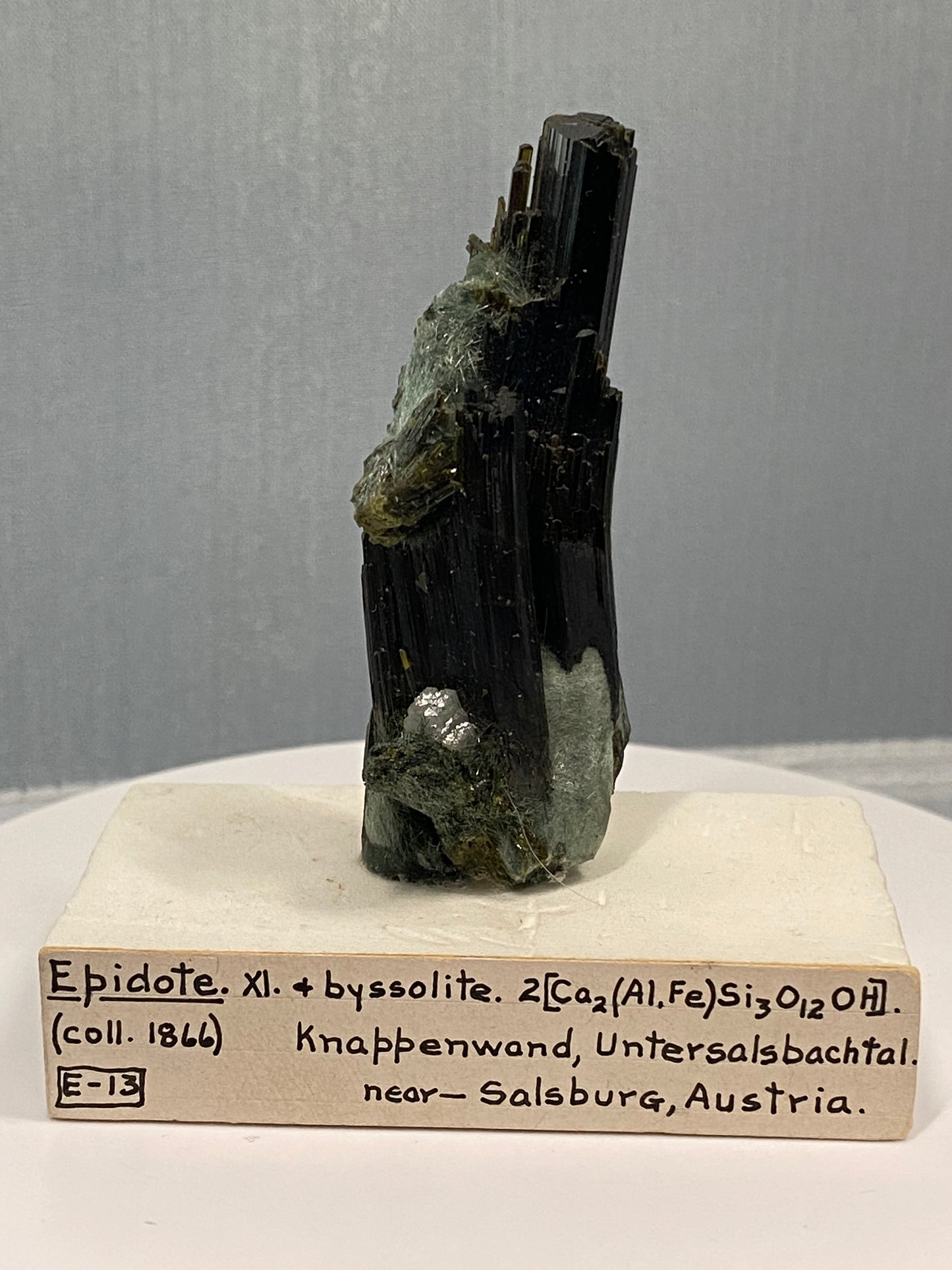 Epidote (bent crystal), Knappenwand, Untersalsbachtal, near Salsburg, Austria (ex-Smithsonian) - Collected 1866