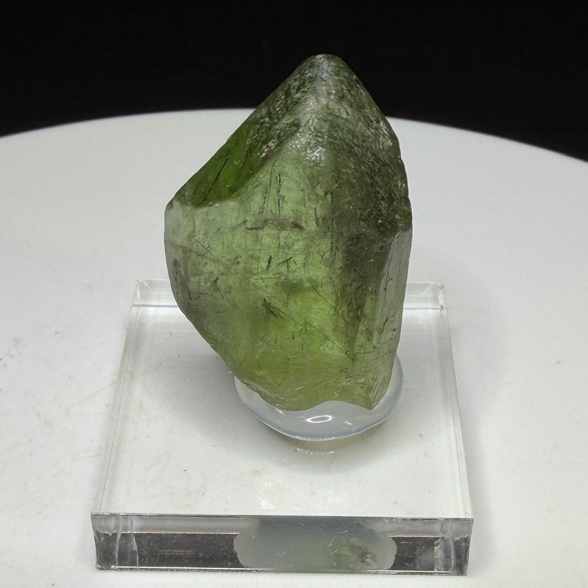 Bright green peridot olivine crystal with ludwigite inclusions from Sapat Gali, Pakistan