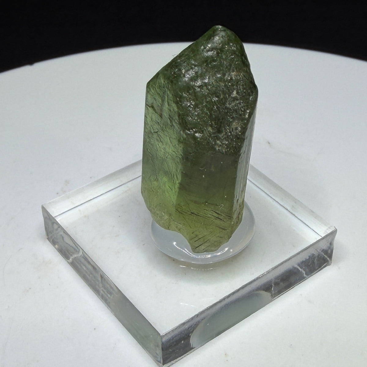Bright green peridot olivine crystal with ludwigite inclusions from Sapat Gali, Pakistan