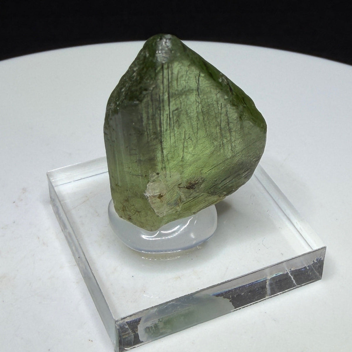Bright green peridot olivine crystal with ludwigite inclusions from Sapat Gali, Pakistan