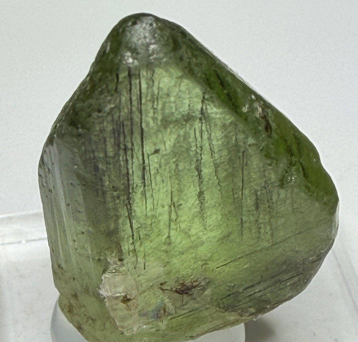Bright green peridot olivine crystal with ludwigite inclusions from Sapat Gali, Pakistan