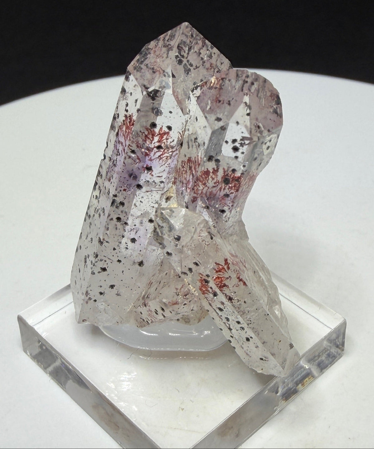 Clear quartz crystals with red and dark hematite inclusions from Goboboseb Mountains, Namibia