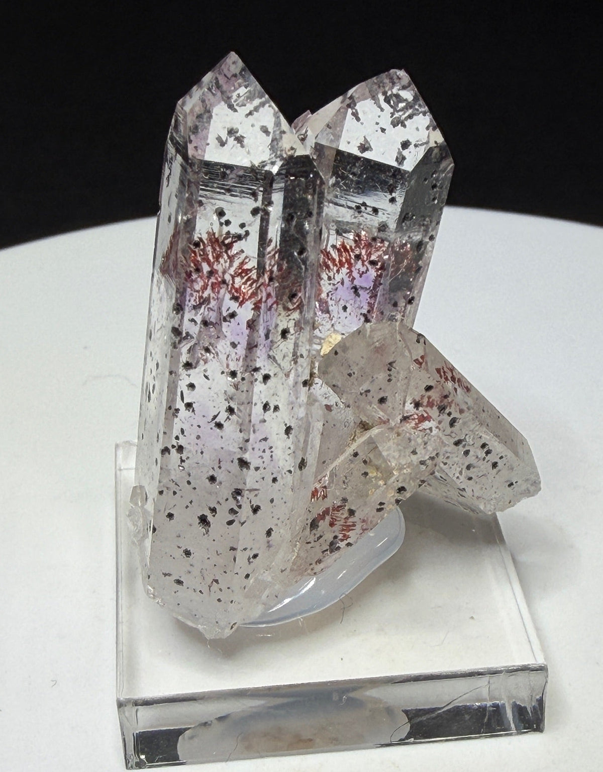 Clear quartz crystals with red and dark hematite inclusions from Goboboseb Mountains, Namibia