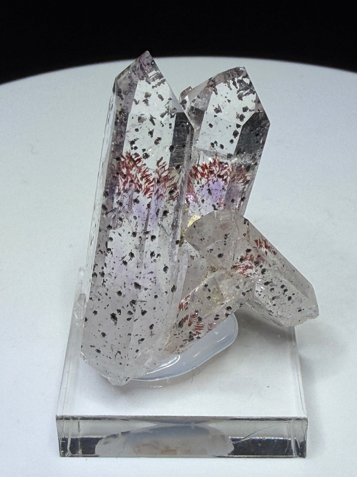 Clear quartz crystals with red and dark hematite inclusions from Goboboseb Mountains, Namibia