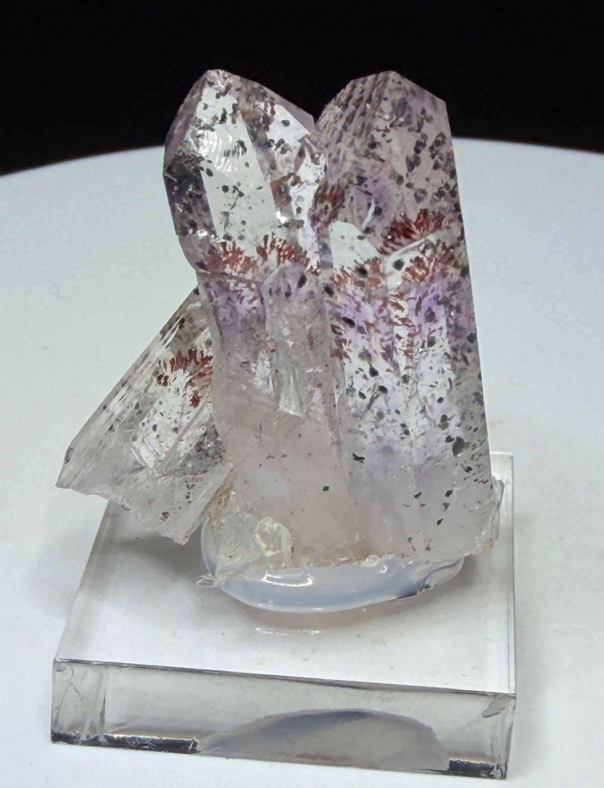 Clear quartz crystals with red and dark hematite inclusions from Goboboseb Mountains, Namibia