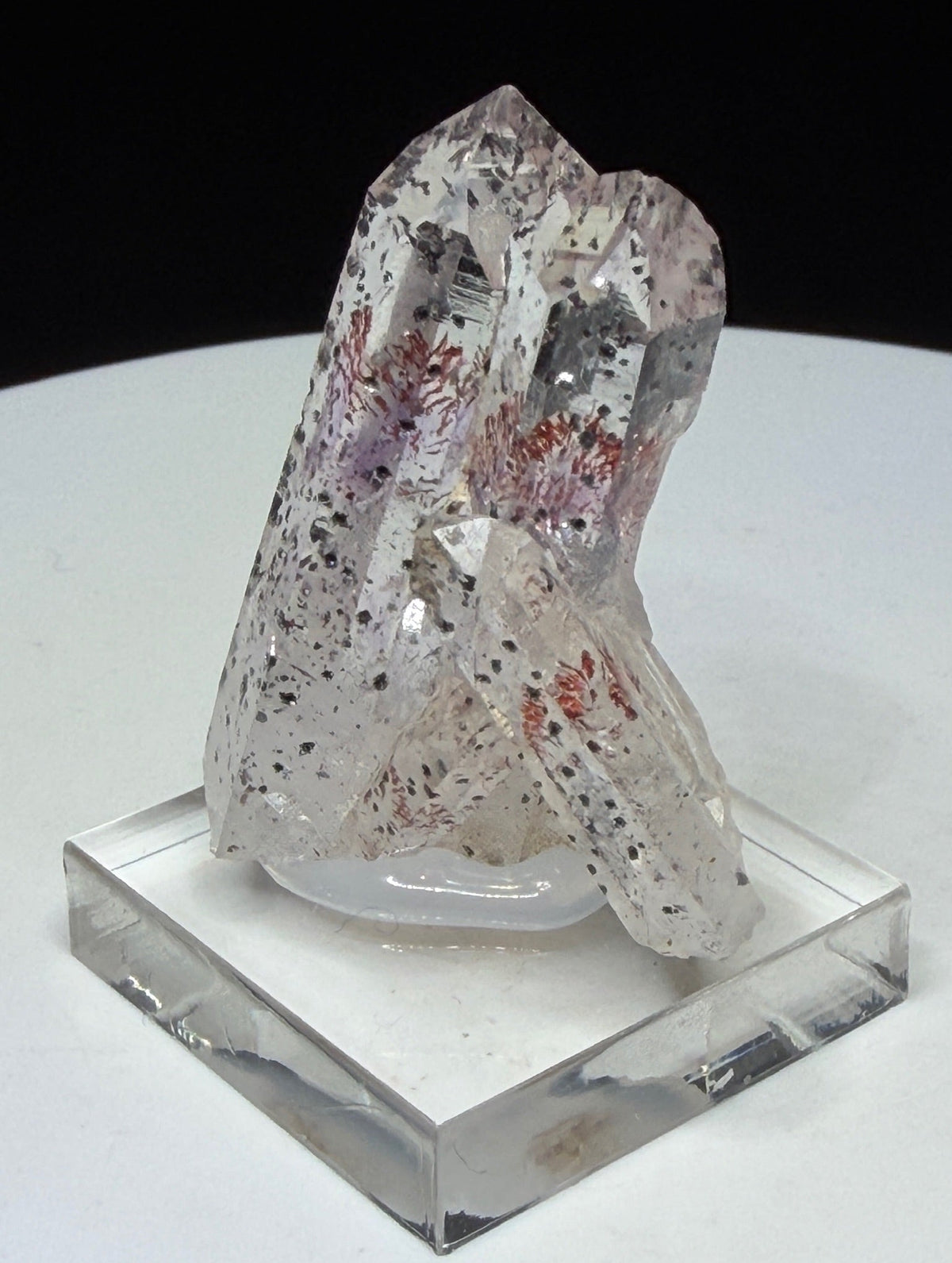 Clear quartz crystals with red and dark hematite inclusions from Goboboseb Mountains, Namibia