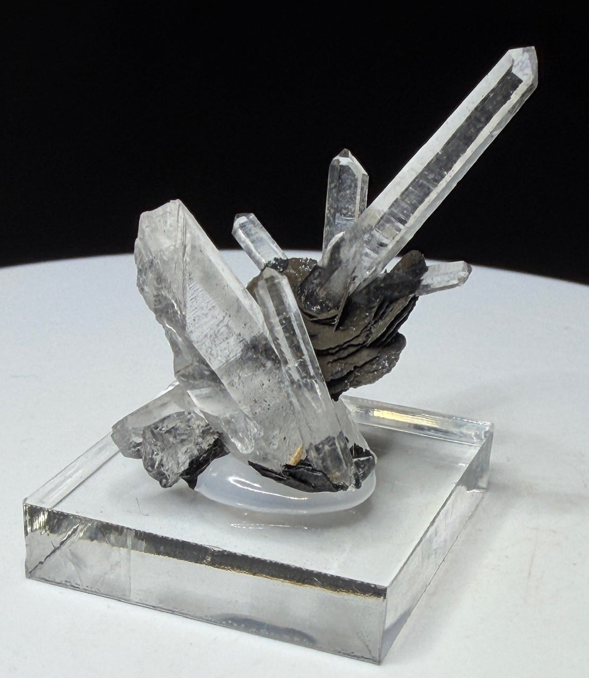 Elongated clear quartz crystals on dark platy hematite from Jinlong Hill, Heyuan, Guangdong, China