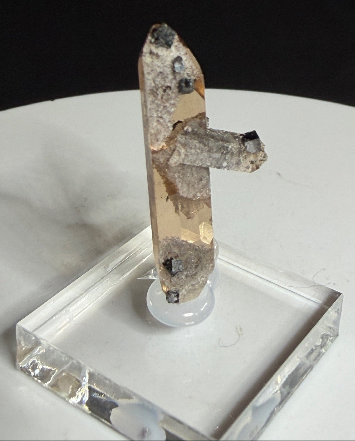 Sherry-colored topaz crystal with black bixbyite crystals from Topaz Mountain, Thomas Range, Utah, USA