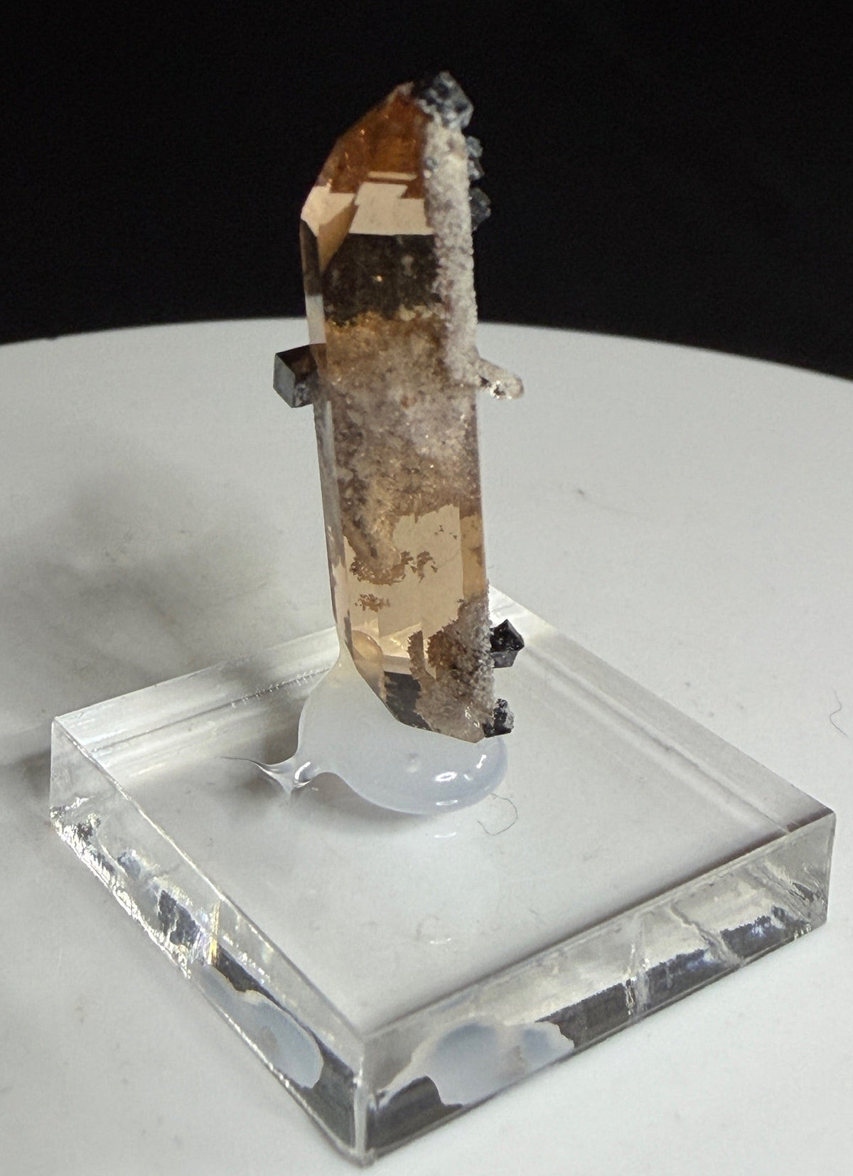 Sherry-colored topaz crystal with black bixbyite crystals from Topaz Mountain, Thomas Range, Utah, USA
