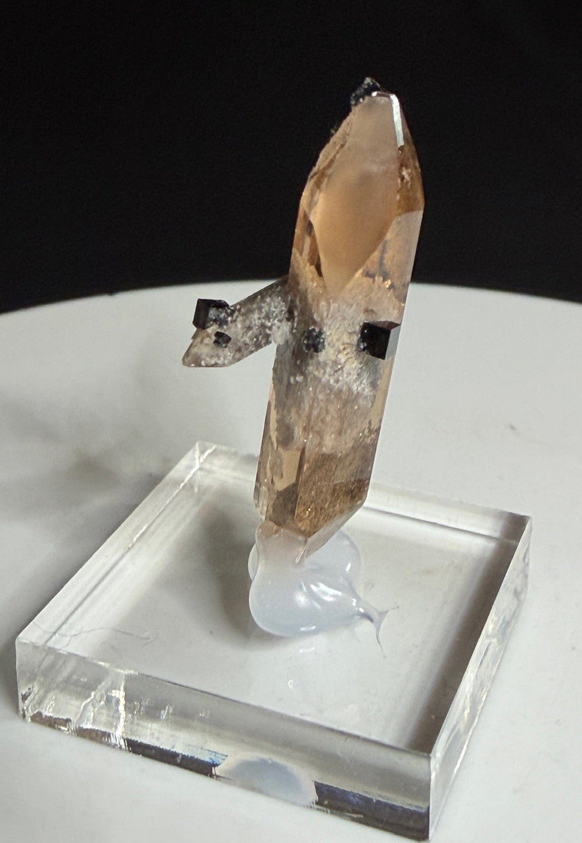 Sherry-colored topaz crystal with black bixbyite crystals from Topaz Mountain, Thomas Range, Utah, USA