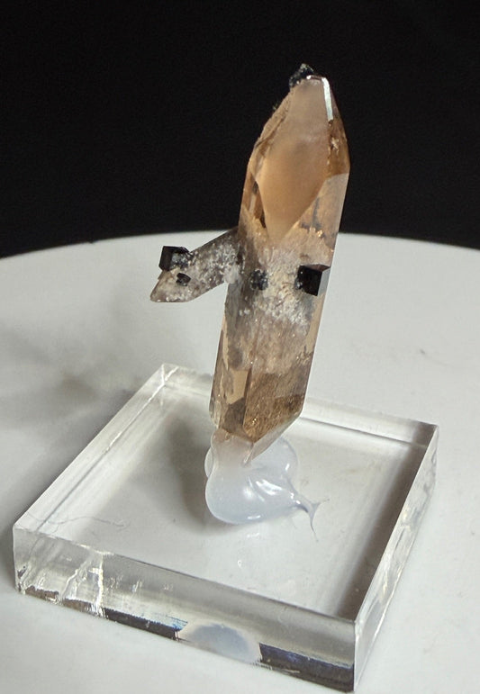 Sherry-colored topaz crystal with black bixbyite crystals from Topaz Mountain, Thomas Range, Utah, USA