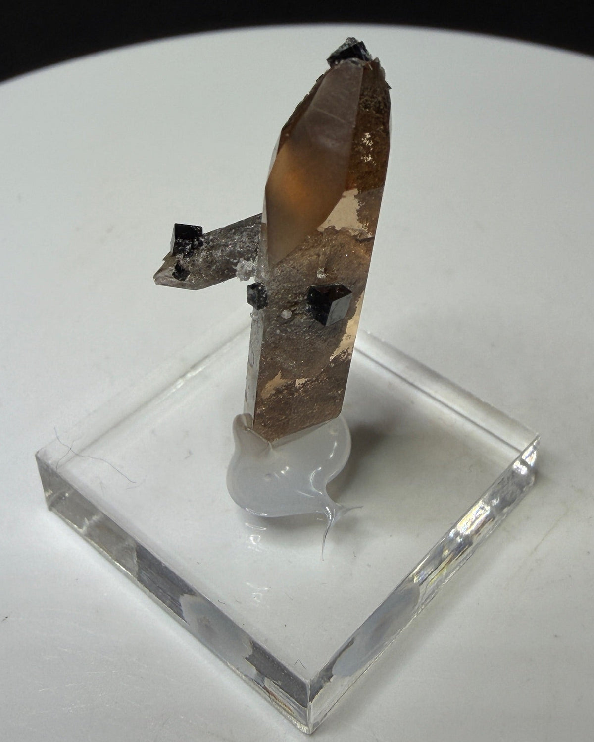 Sherry-colored topaz crystal with black bixbyite crystals from Topaz Mountain, Thomas Range, Utah, USA
