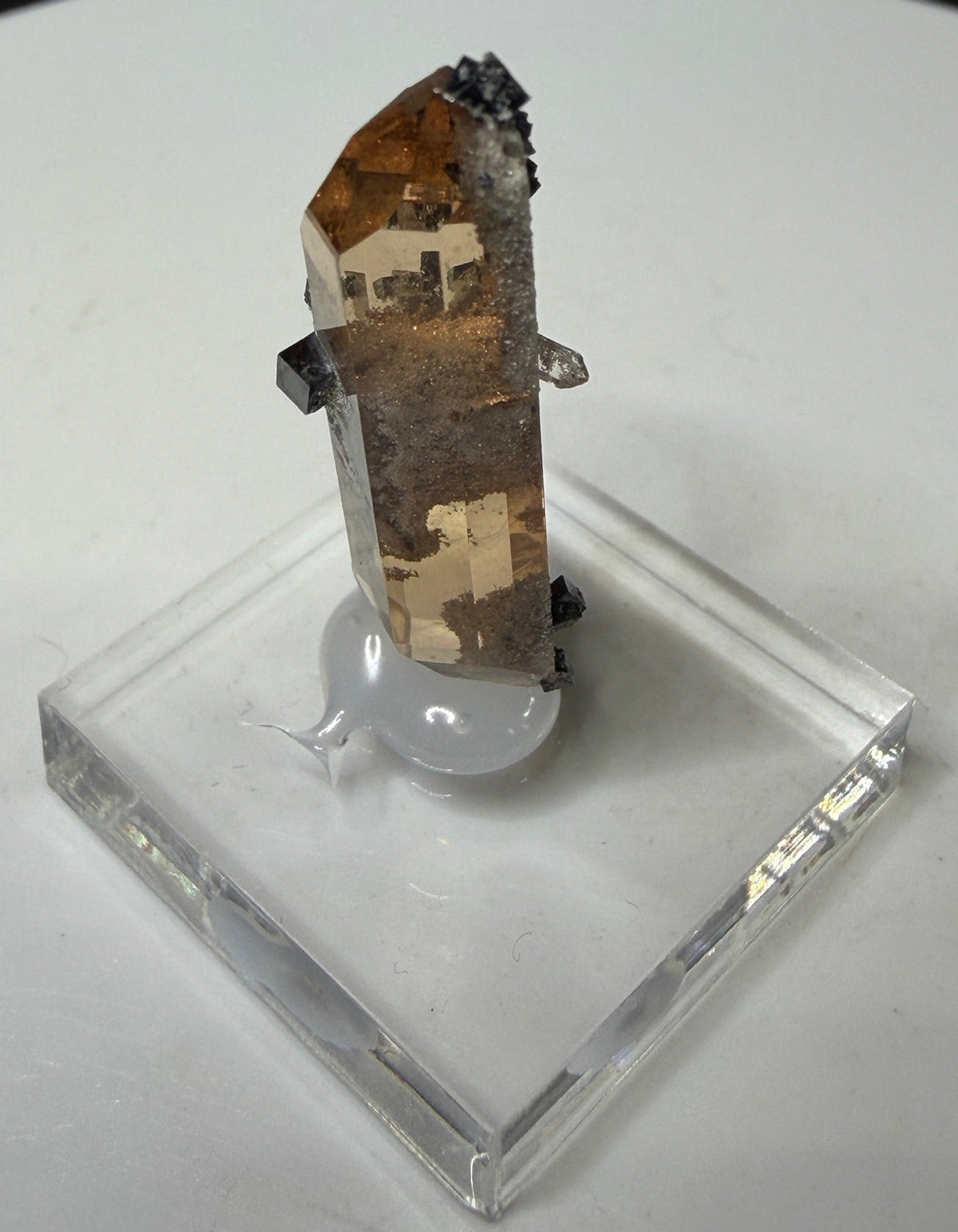 Sherry-colored topaz crystal with black bixbyite crystals from Topaz Mountain, Thomas Range, Utah, USA