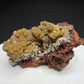 Golden-yellow mimetite crystals on pale pink calcite from the Santa Eulalia Mining District, Chihuahua, Mexico.