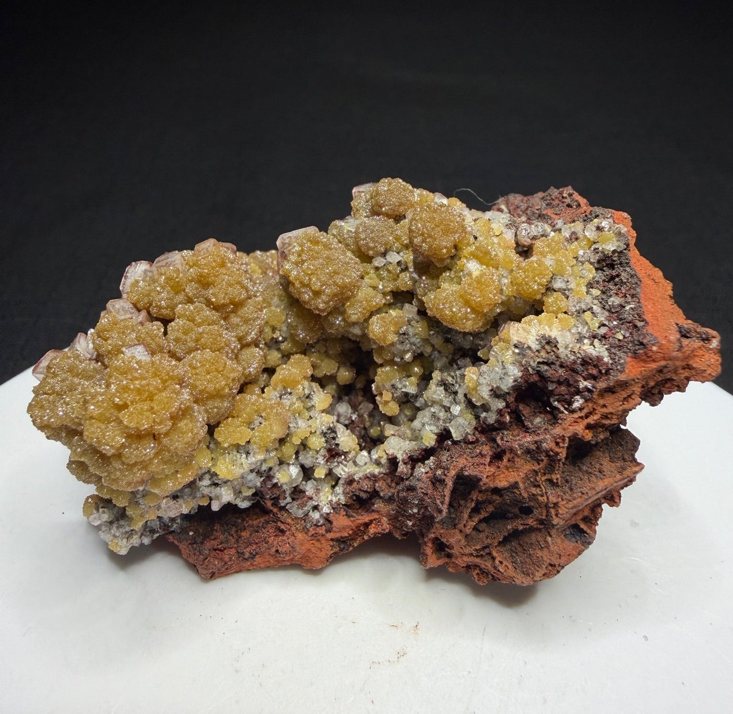 Golden-yellow mimetite crystals on pale pink calcite from the Santa Eulalia Mining District, Chihuahua, Mexico.