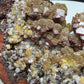 Golden-yellow mimetite crystals on pale pink calcite from the Santa Eulalia Mining District, Chihuahua, Mexico.