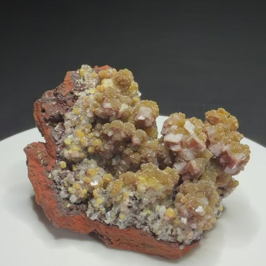 Golden-yellow mimetite crystals on pale pink calcite from the Santa Eulalia Mining District, Chihuahua, Mexico.