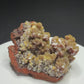 Golden-yellow mimetite crystals on pale pink calcite from the Santa Eulalia Mining District, Chihuahua, Mexico.