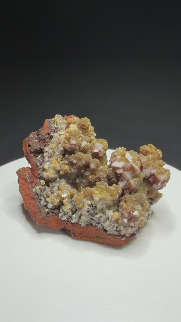 Golden-yellow mimetite crystals on pale pink calcite from the Santa Eulalia Mining District, Chihuahua, Mexico.