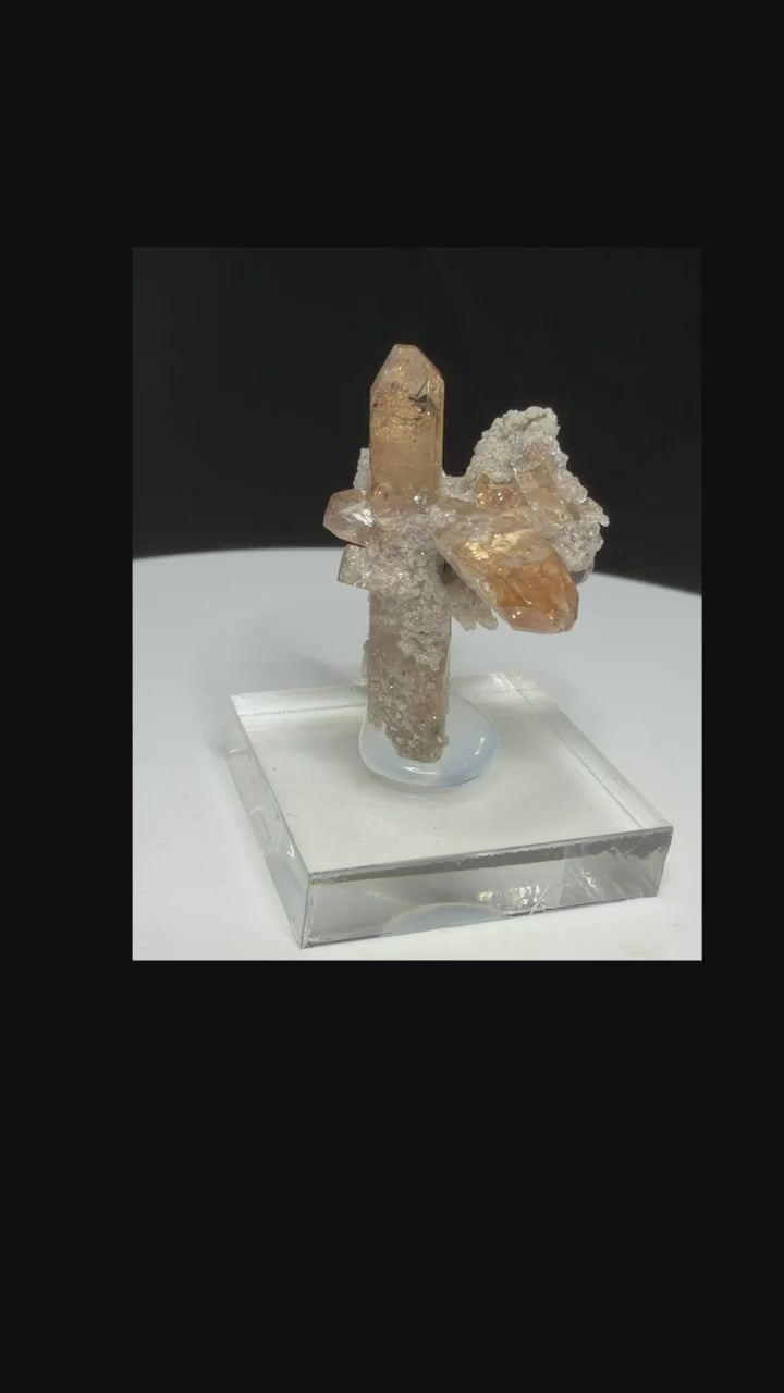 Sherry-colored topaz crystal with black bixbyite crystals from Topaz Mountain, Thomas Range, Utah, USA