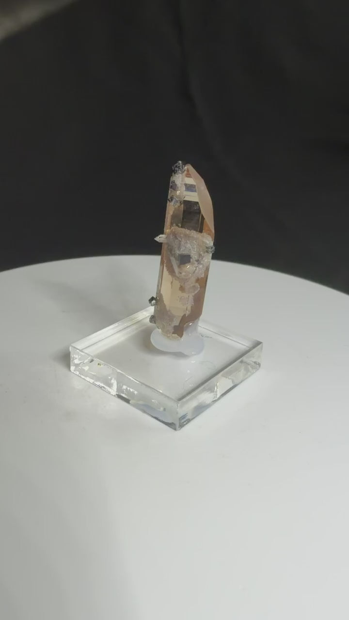 Sherry-colored topaz crystal with black bixbyite crystals from Topaz Mountain, Thomas Range, Utah, USA