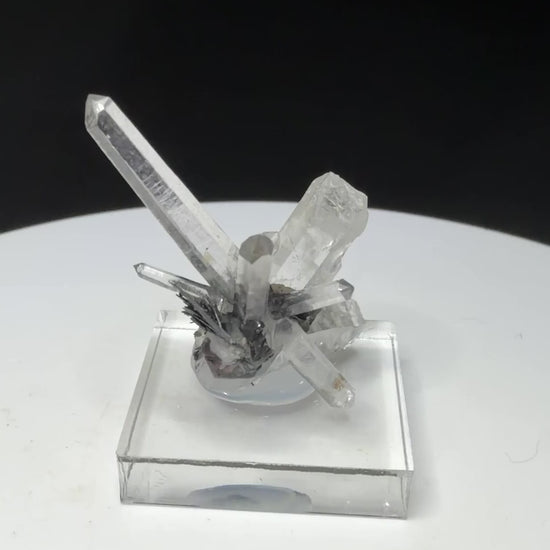 Elongated clear quartz crystals on dark platy hematite from Jinlong Hill, Heyuan, Guangdong, China