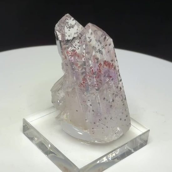 Clear quartz crystals with red and dark hematite inclusions from Goboboseb Mountains, Namibia