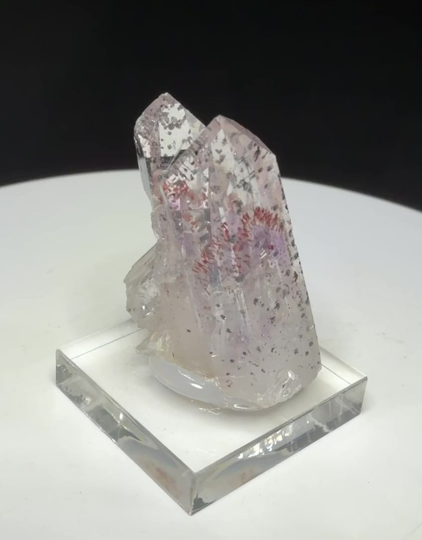 Clear quartz crystals with red and dark hematite inclusions from Goboboseb Mountains, Namibia