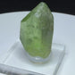 Bright green peridot olivine crystal with ludwigite inclusions from Sapat Gali, Pakistan