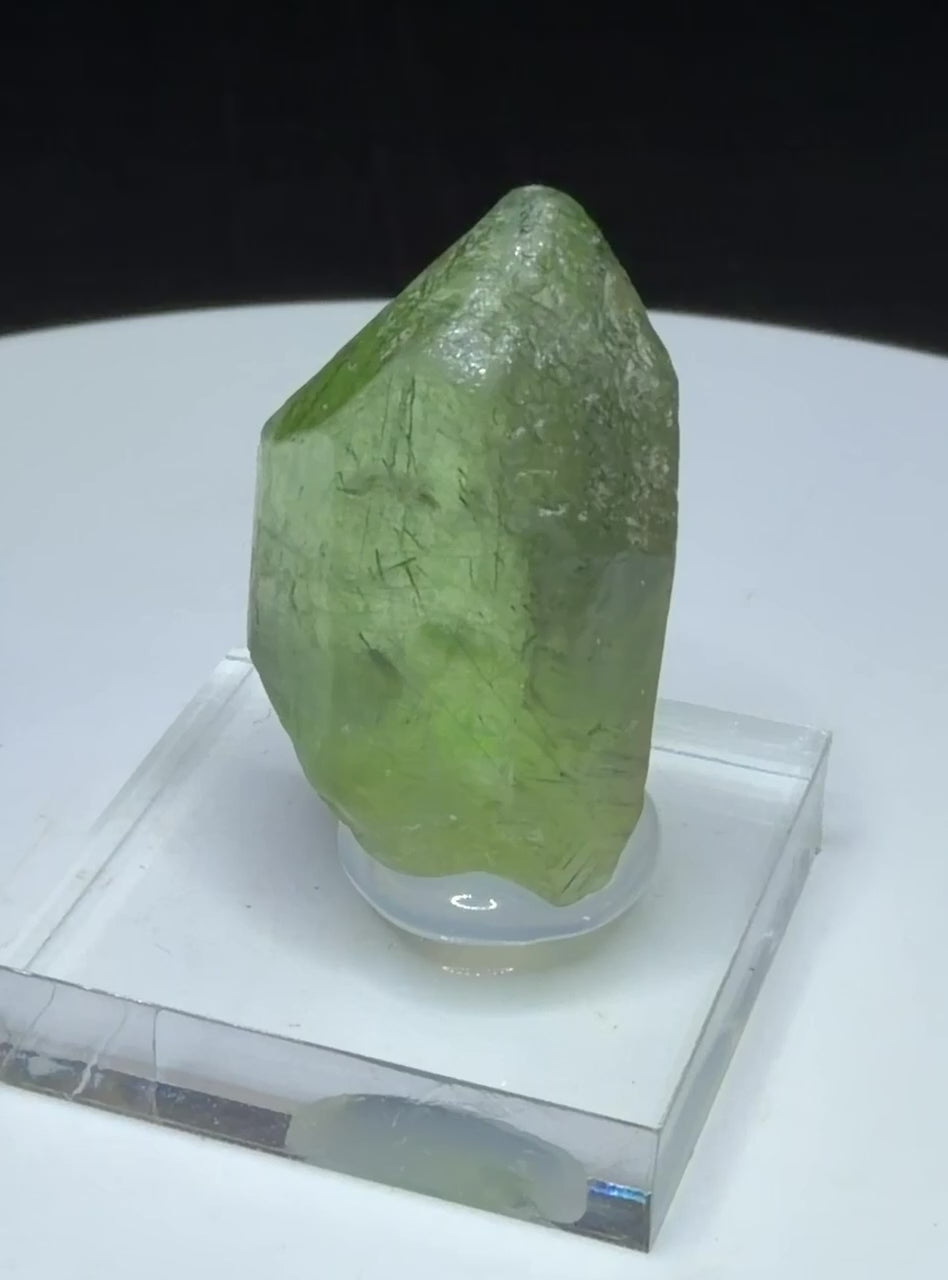 Bright green peridot olivine crystal with ludwigite inclusions from Sapat Gali, Pakistan