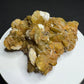 Golden-brown siderite crystal cluster from Morro Velho Mine, Brazil, displayed on a white stand