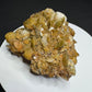 Golden-brown siderite crystal cluster from Morro Velho Mine, Brazil, displayed on a white stand