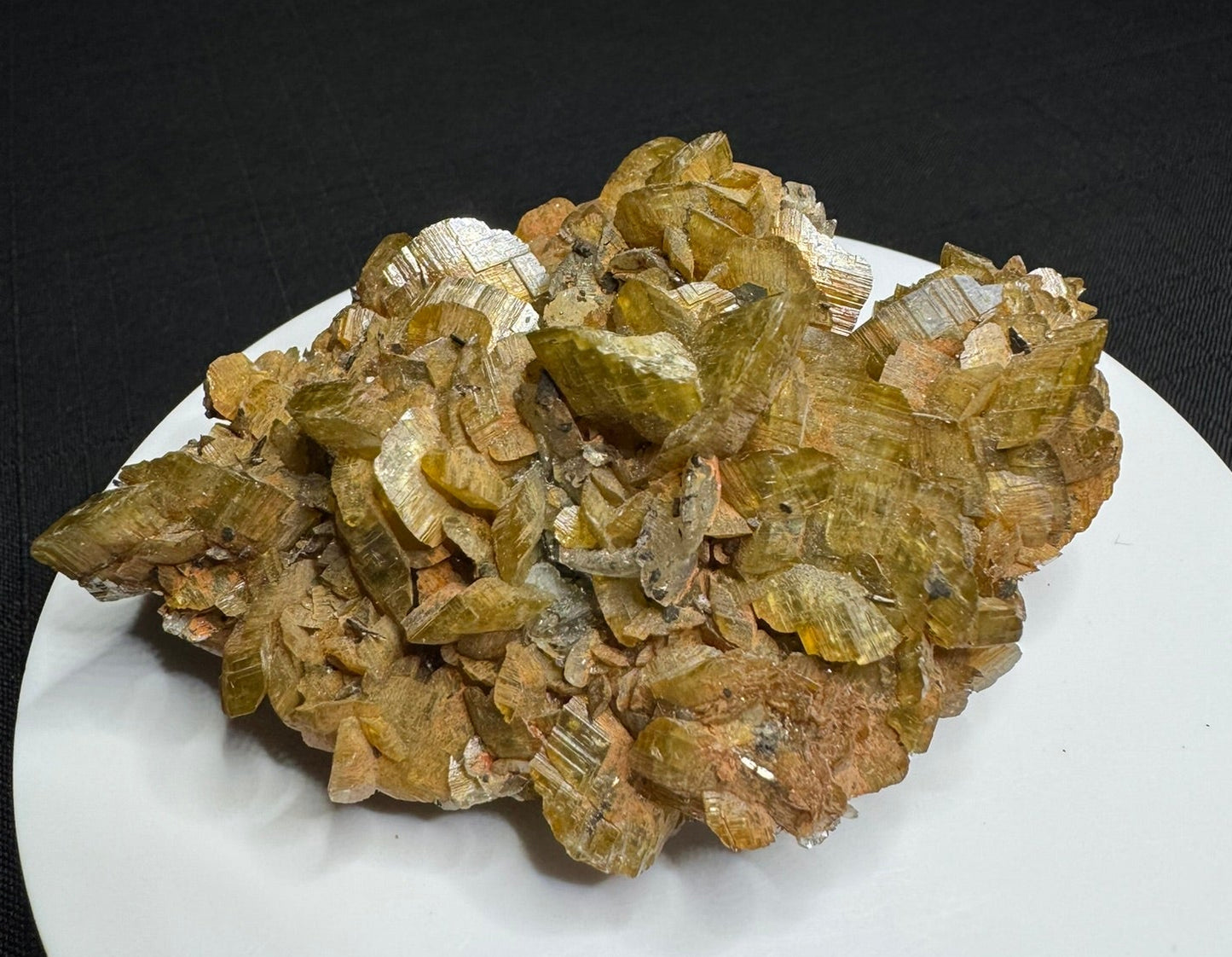 Golden-brown siderite crystal cluster from Morro Velho Mine, Brazil, displayed on a white stand
